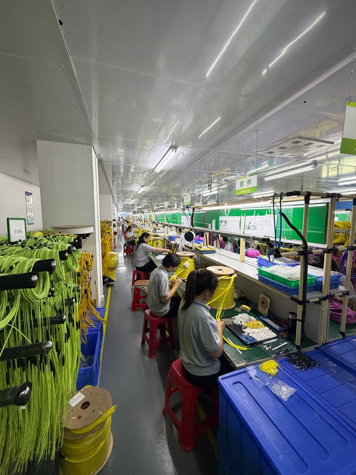 Fiber cable assembly operators working on a Huawellux production line