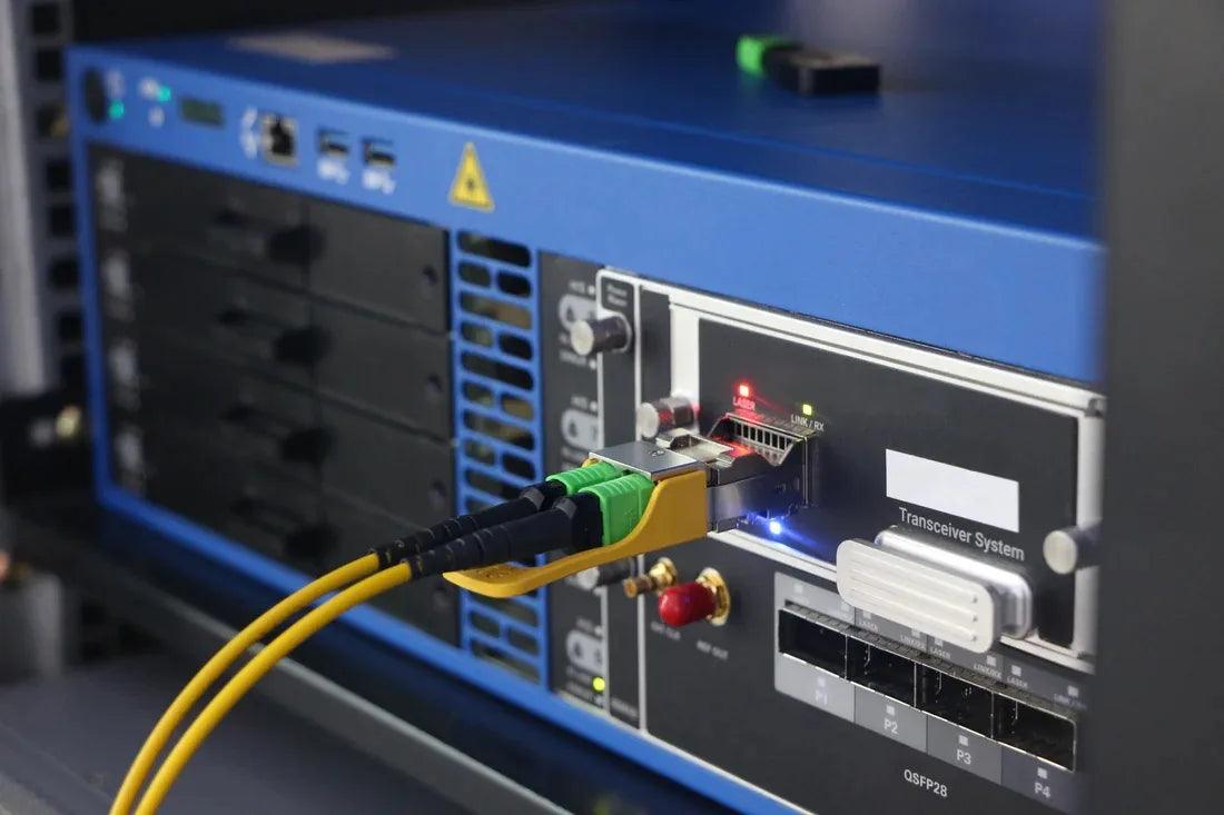 Fiber optic cables connected to optical test equipment.